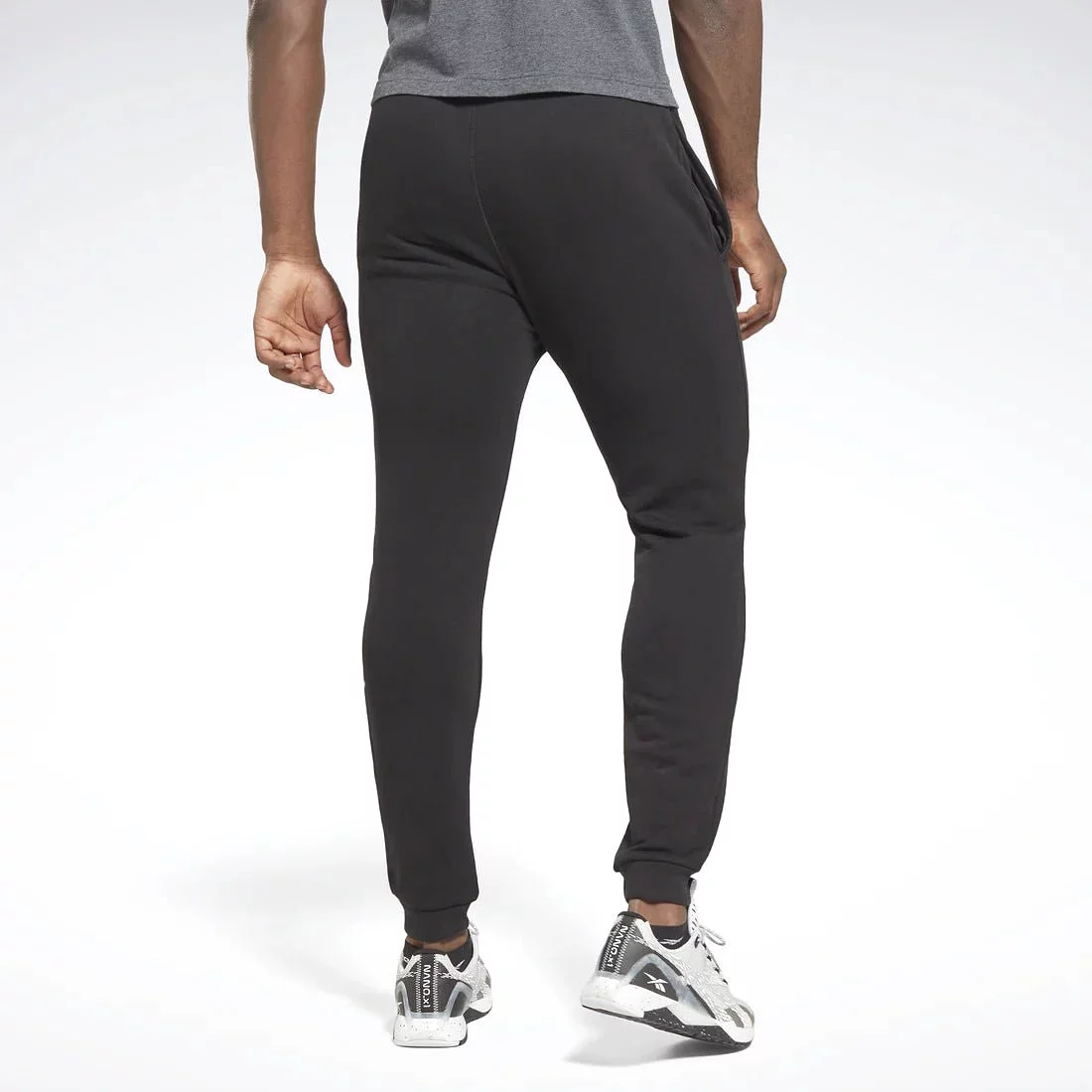 Reebok men's black trackpants with small vector design.